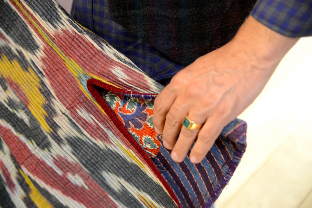 Bukharan silk design on an Afghan robe, part of the travel stories and travel adventures in the Tashkurgan bazaar. (Image © Meredith Mullins.)
