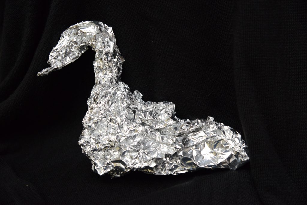 An aluminum foil swan, an artistic doggy bag, part of the different cultures approach to restaurant leftovers. (Image © Meredith Mullins.)
