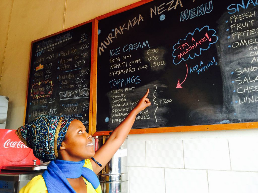 Sweet Dreams manager and menu board, breaking cultural barriers in Rwanda. (Image courtesy of Liro Films.)