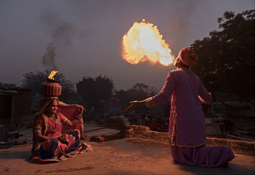 Fire breather in the Kathputli Colony, showing cultural encounters in the slums of India. (Image © Chester Ng.)