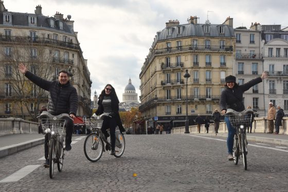 Three velib riders in Paris France, illustrating the wordplay in the French language of veliberation. (Image © Meredith Mullins.)