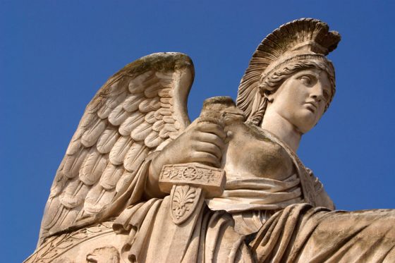 An armored angel against a blue sky in Paris, one of the angels of Paris that serves as a cultural symbol. (Image © Hemera/Ablestock.com.)