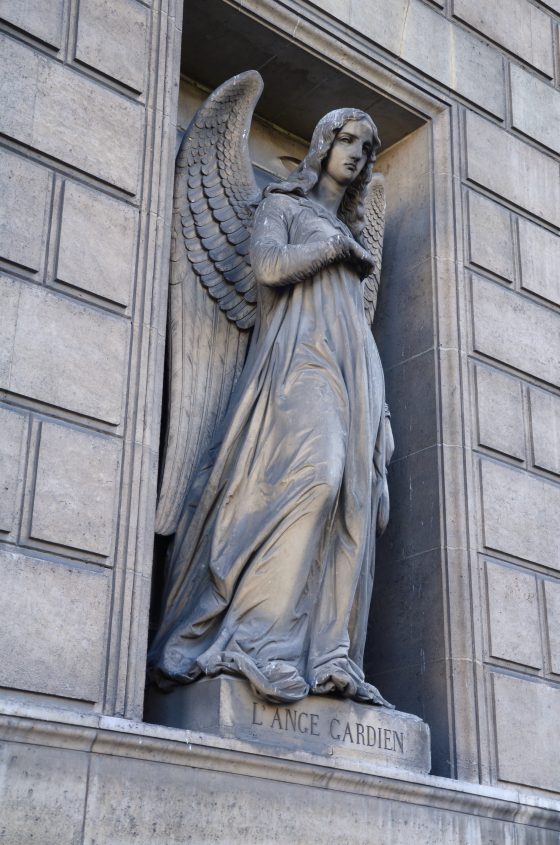 Guardian angel on the side of the Church of the Madeleine in Paris, one of the Paris angles that serves as a cultural symbol. (Image © Rosemary Flannery.)