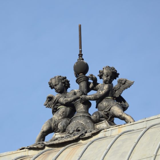 Two angels and a spire atop the Theatre de Châtelet in Paris, one of the Paris angels that serves as a cultural symbol. (Image © Rosemary Flannery.)