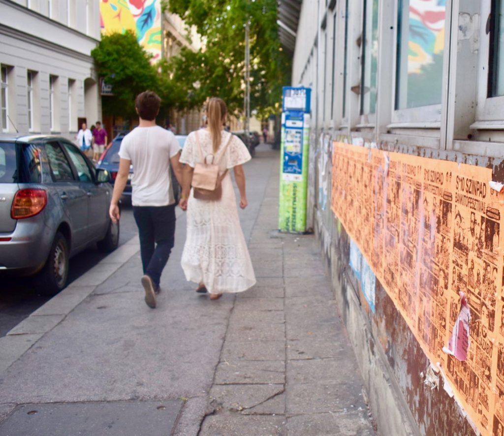 A couple walking hand in hand in Budapest show the power of saying hello across cultures. (Image © Joyce McGreevy)