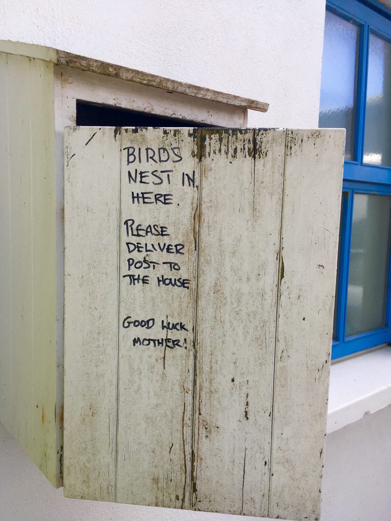 A handmade sign on a mailbox in Baltimore, Ireland, shows the wordplay, wit, and wisdom of signage in public spaces. Image © Joyce McGreevy
