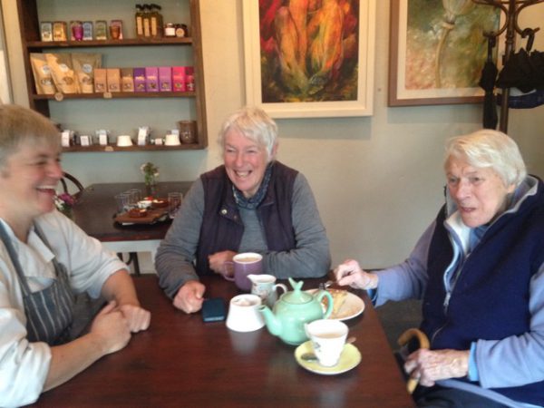 Three women taking tea and trading stories at Glebe Gardens Café, Co. Cork, reflect the Irish tradition of the party piece, sharing stories, songs, and poems. (Image © Rick Chelew)