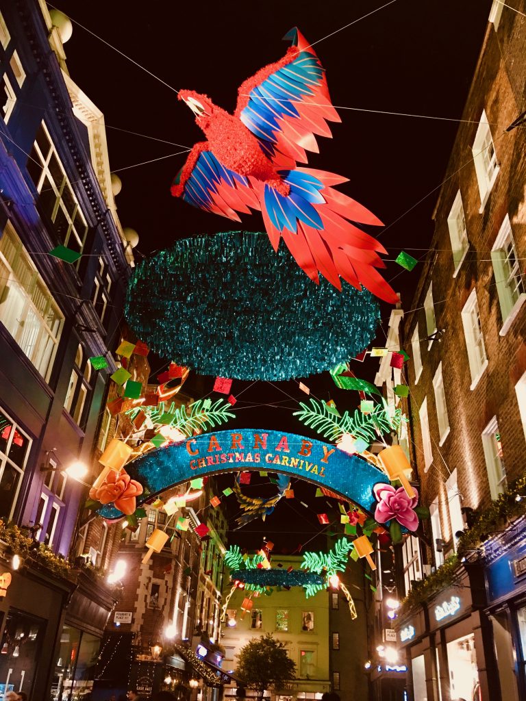 Tropical decorations over Carnaby St, London inspire wanderlust for an English holiday ramble. (Image © Joyce McGreevy)
