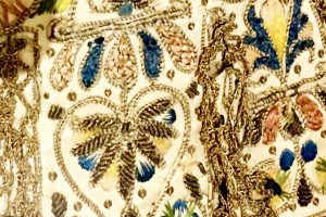 Silver and gold embroidery at a textile exhibition in Glasgow reflect the gilt-y pleasures of wordplay and clothing idioms. (Image © Joyce McGreevy)