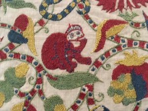 A detail of a 17th century cap at a textile exhibition in Glasgow, Scotland "puts a cap on" clothing idioms and wordplay. (Image © Joyce McGreevy)
