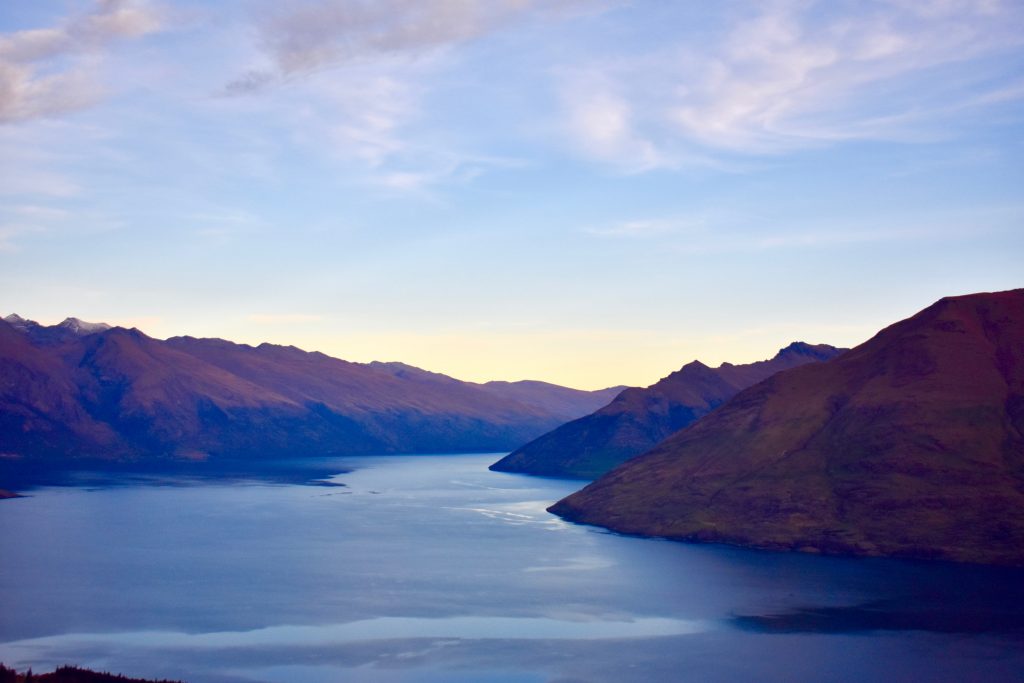 A view down Lake Wakatipu to The Remarkables mountain range in Queenstown Hill is a treat for visitors who are walking New Zealand. (Image © Joyce McGreevy)