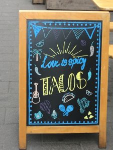 A sign advertising tacos in Copenhagen counters cultural stereotypes about dining in Denmark. (Image © Joyce McGreevy)