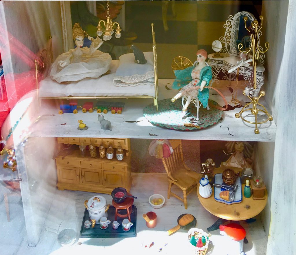 A dollhouse in a store window in Sofia, Bulgaria leads a writer to ponder the travel inspiration we find in souvenirs. (Image © Joyce McGreevy)