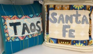 Mass-produced pillows in California lead a writer to ponder why people find travel inspiration in souvenirs. (Image © Joyce McGreevy)