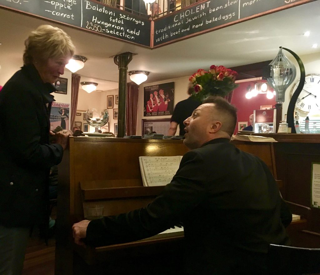 A patron and pianist at Spinoza Café, where the best travel tip is to savor the Budapest experience. Image © Joyce McGreevy 