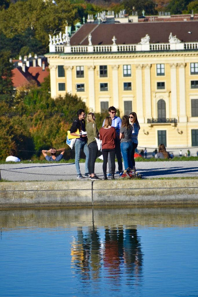 People conversing near water in Vienna, Austria become a metaphor for speaking two languages. (Image © Joyce McGreevy)
