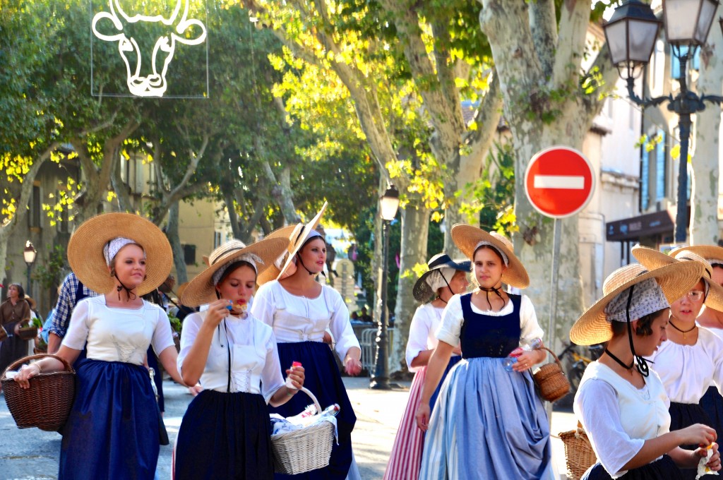 Women tossing lavender in parade celebrating French cultural heritage and traditions