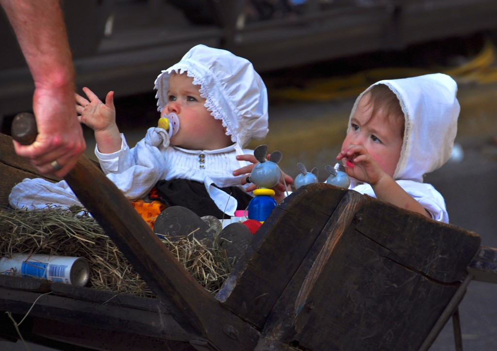 Pushcart babies in parade celebrating French cultural heritage and traditions