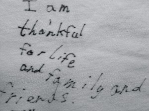 Thanksgiving tablecloth, showing a thankful message in a record of life's changes