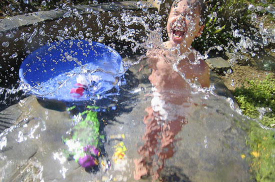 Child playing in pool, photographed by a blind photographer using a creative process to see differently.