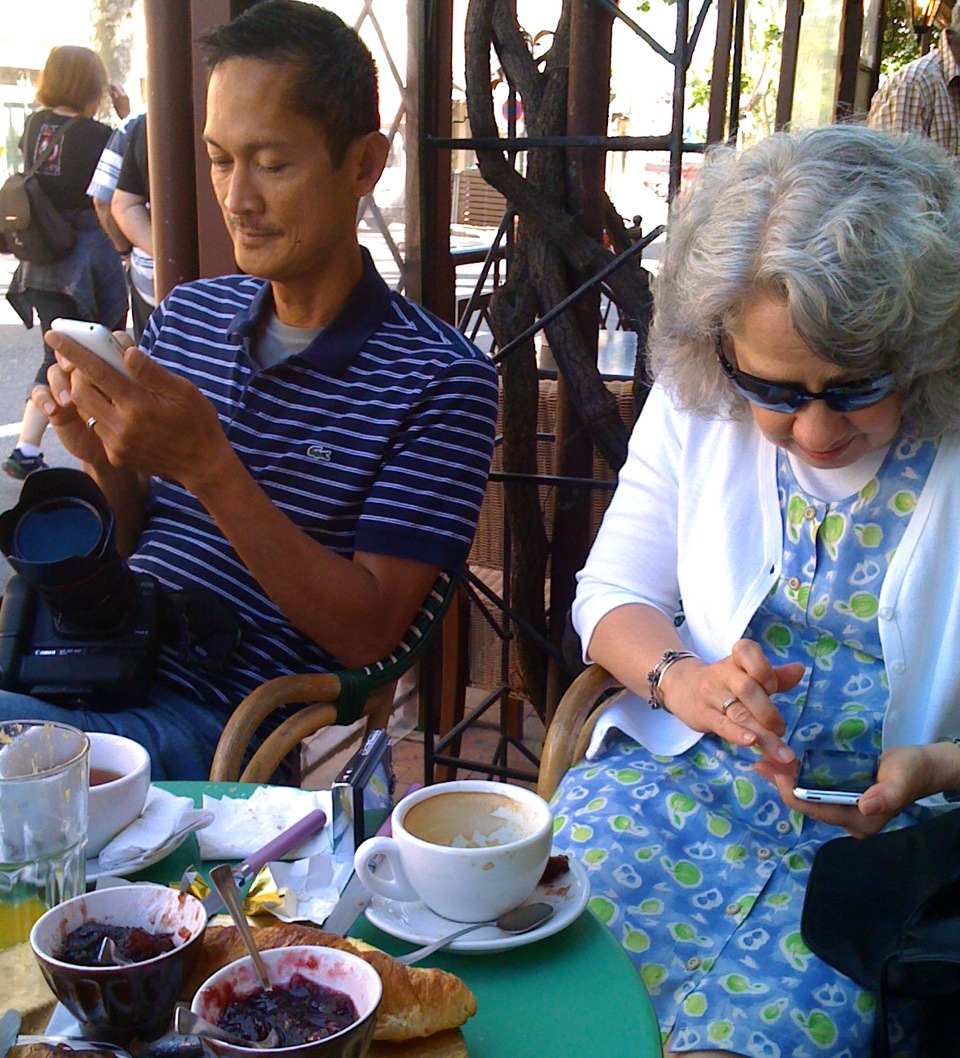 people using smartphones, showing how technology in everyday life can keep us from communicating