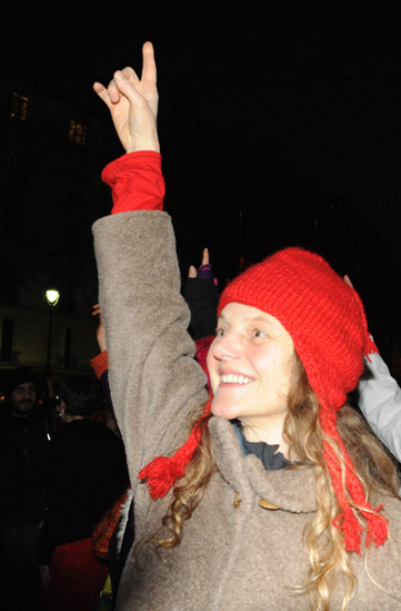 Participant in One Billion Rising raises the one billion sign in a life changing moment to stop violence against women.