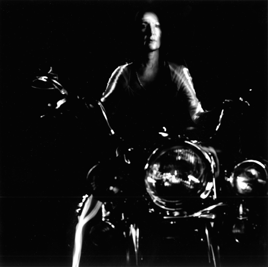 Stephanie, woman on motorcycle, captured by blind photographer Pete Eckert in a moment of creative inspiration
