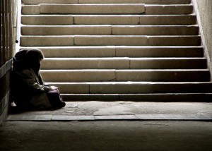 Homeless woman at the bottom of stairs, helping us see things differently