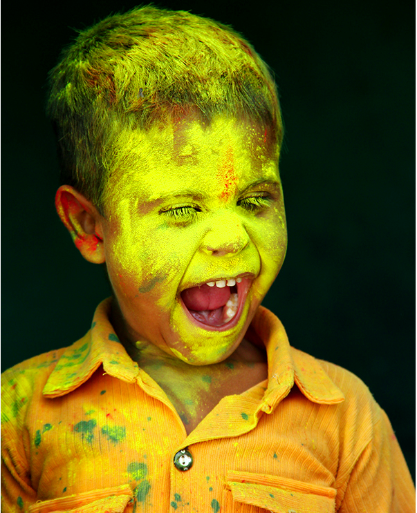 A Young Boy Playing Holi, a Hindu Cultural Tradition