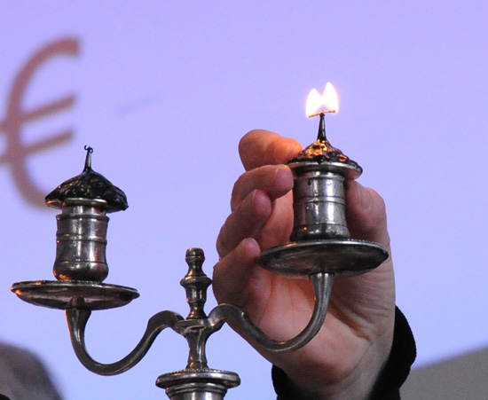 Lighting of the candle at the Chambres des Notaires auction by the candle, a Paris cultural experience that mixes old with new.