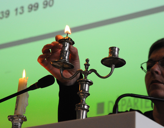 Lighting the first candle at the auction by the candle, a cultural experience that mixes old and new.