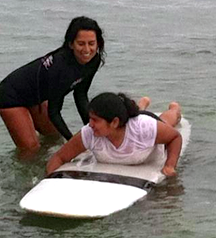 Girl achieving success through surfing with The Wahine Project