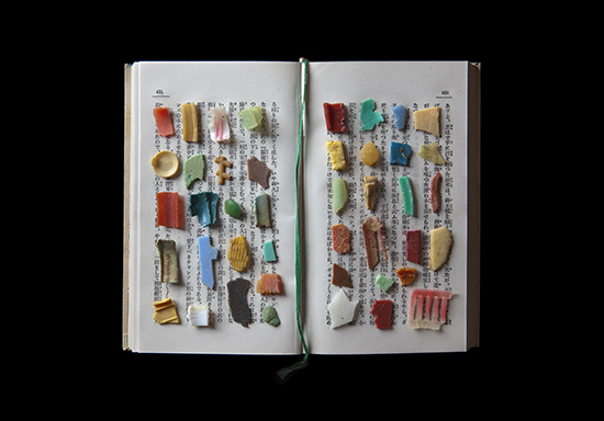 Plastic remnants on a book in Jerry Takigawa's artistic expression of the tragedy of world oceans