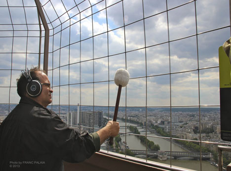rtolozzi with large mallet playing fence, artistic expression on the Eiffel Tower.