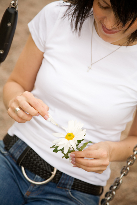 Girl playing daisy love game that varies across different cultures