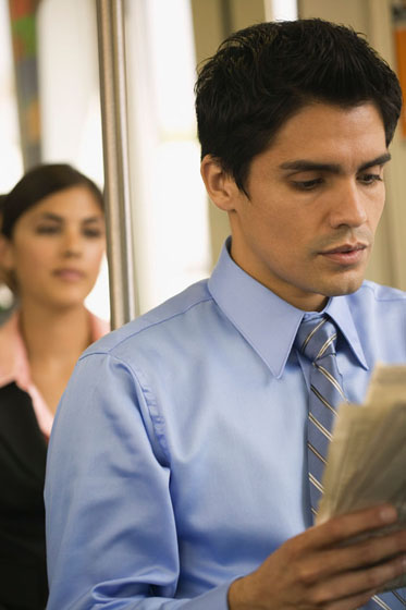 Woman looking a man with newspaper, a missed connection or a life lesson about carpe diem