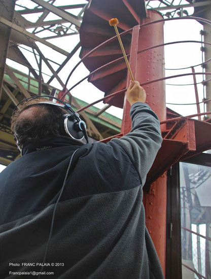 Joe Bertolozzi playing spiral stairs, artistic expression making music with the Eiffel Tower.