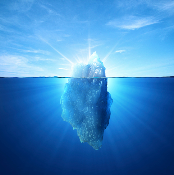 An iceberg above and below the water line, serving as a metaphor for the cultural iceberg in which the visible tip of surface culture belies the "deep culture" vastness hidden below the surface. 
