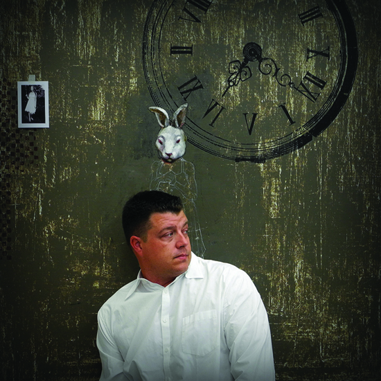 Craig Alan in front of a clock, an artist who uses people as pixels for creative expression (Image © Henrik Abedian)