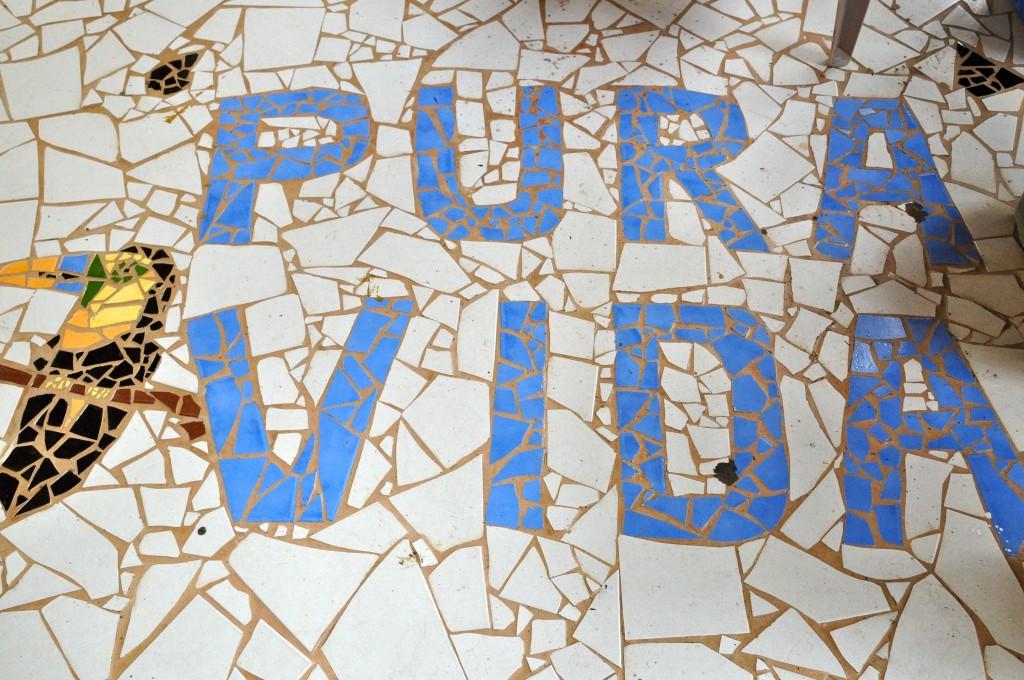 Tile floor showing the traditional Costa Rican greeting "Pura Vida," which represents deeper cultural values on the love of life