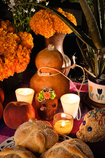 A display of food and candles for Day of the Dead, Halloween traditions and cultural traditions from Mexico (Image © iStock)