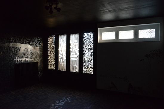 Arabic lettering in dark room, artistic expression of street art at the Tour 13 (Photo © Meredith Mullins)