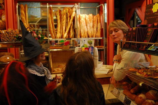 Trick-or-treaters at a French bakery, showing Halloween traditions and cultural traditions of France (Photo © Meredith Mullins)