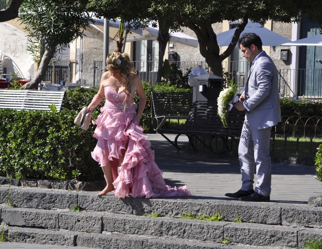 Couple standing in a Sicilian plaza after a wedding that reflected their cultural heritage. Image © Sheron Long.