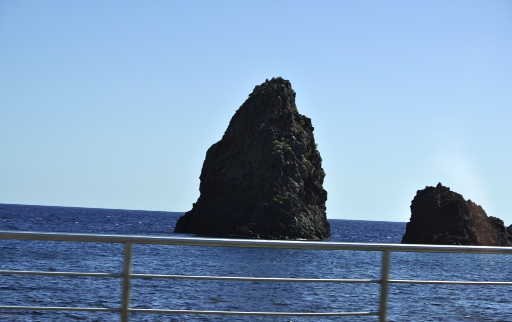 Rocks off the eastern coast of Sicily, part of Greek mythology from Homer's Odyssey and thrown by the cyclops to stop Odysseus, figure in the cultural heritage of Sicily. Image © Sheron Long.