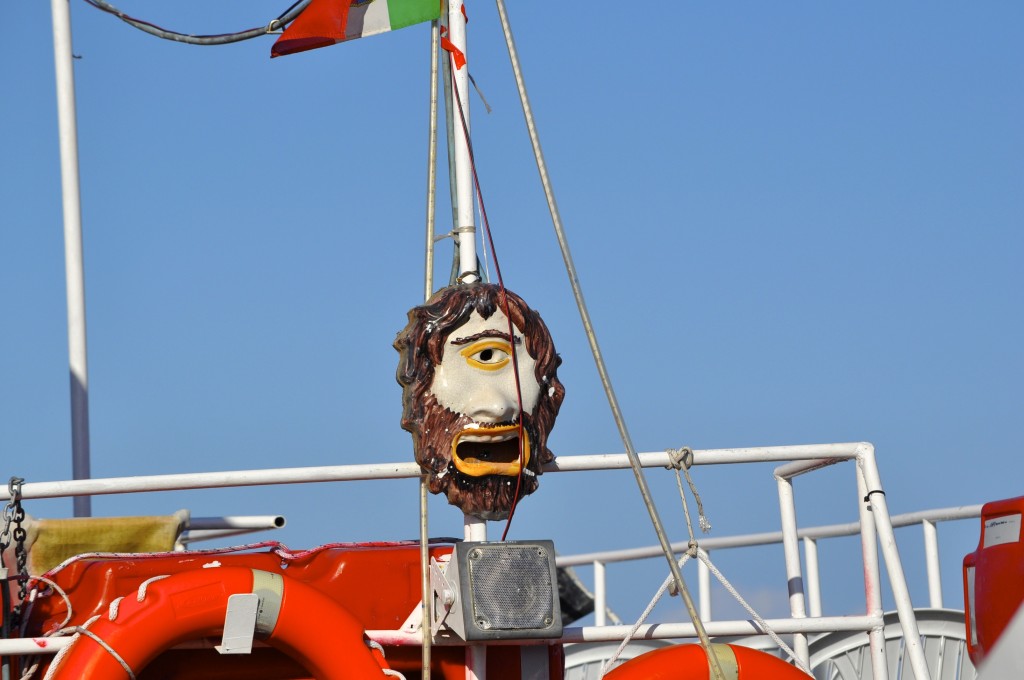 Cyclops' face on a boat in Aci Trezza, Sicily, recalls the country's Greek cultural heritage.  Image © Robert Long.