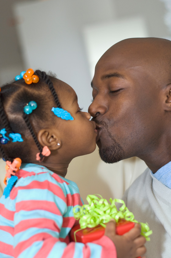 Girl giving gift to father, illustrating a proverb from world cultures. (Image © Todd Wright / Blend Images)