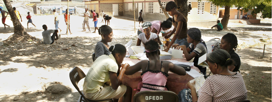 OFEDA women in Haiti overcoming obstacles through work on their handmade cards. (Image © Paula Allen)