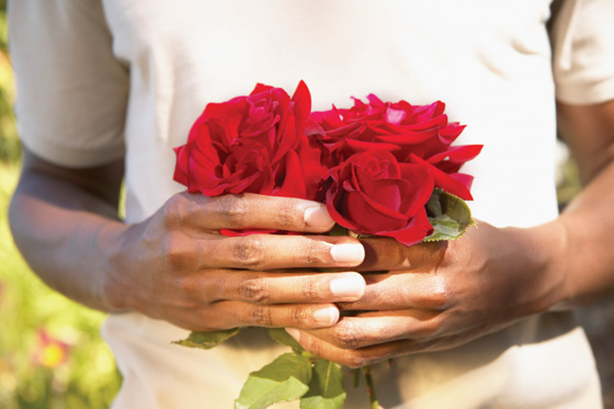 Man holding roses for gift giving. (Image © Plush Studios / Blend Images)
