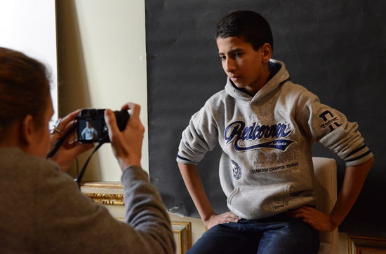 Boy being photographed as Muhammad Ali, creative inspiration from Yousuf Karsh's photographs of 20th century heroes (Photo © Meredith Mullins)